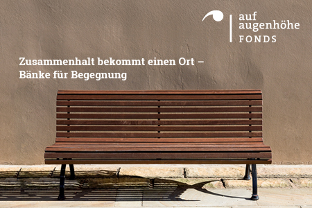 Photo of a bench with a logo and a sign indicating that the benches are for socializing