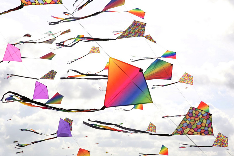 Colorful kites of different sizes in the wind