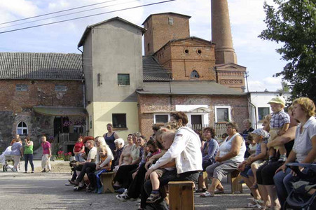 Visitors in front of one building at the village project