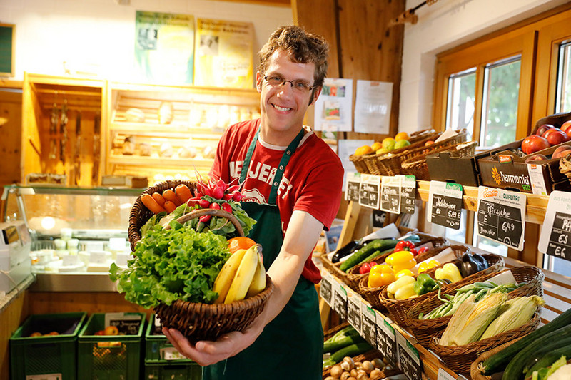 Man in the farm shop with a filled shopping basket