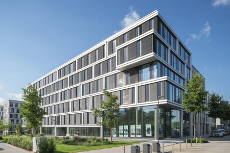 Colours-Gebäude mit Grünpflanzen und im Sonnenlicht