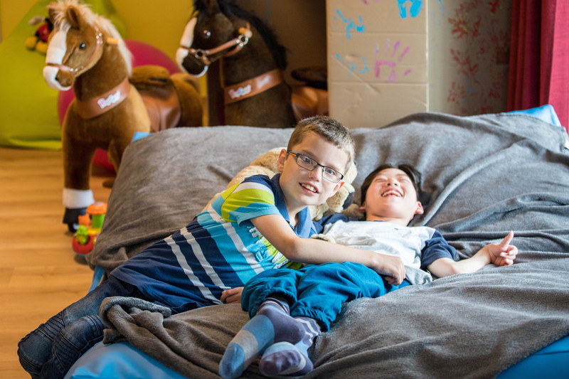 Two friends make themselves comfortable on large pillows