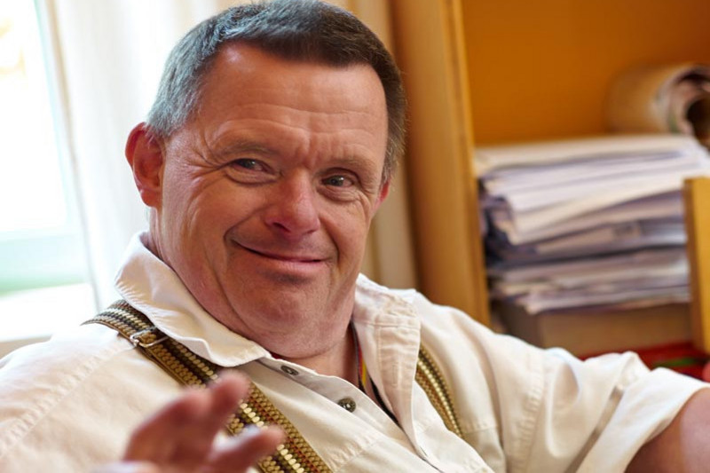 A smiling middleaged man in a bureau