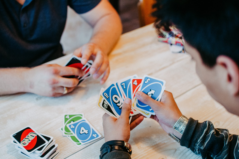 Young people play cards together