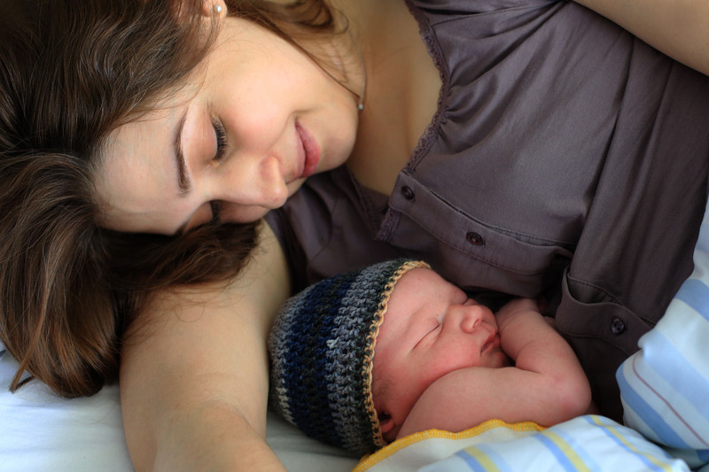 Mother after breastfeeding with child in her arms