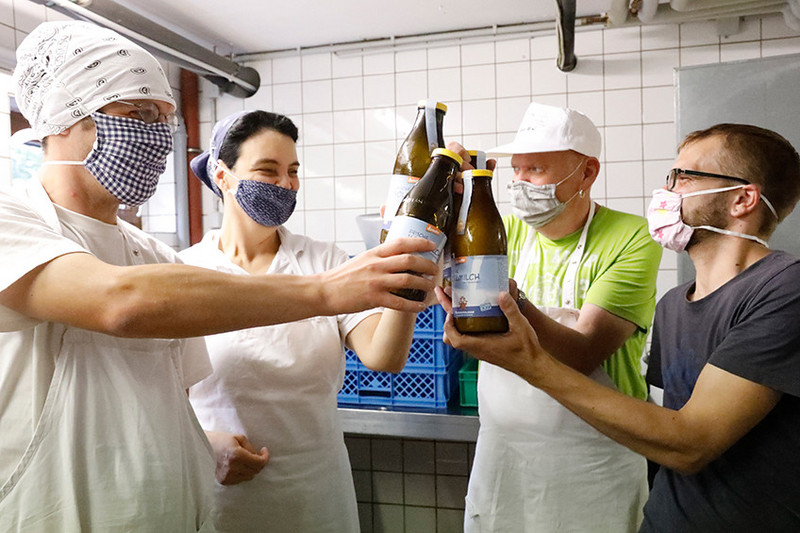 Dairy employees toast with milk bottles