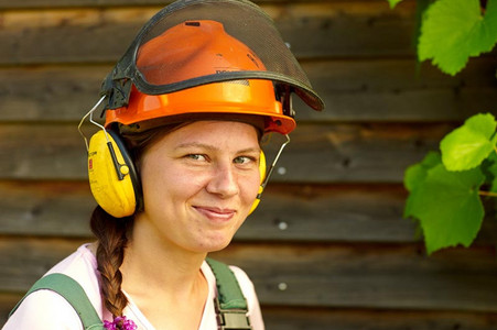 A young woman with a protective helmet, smiling
