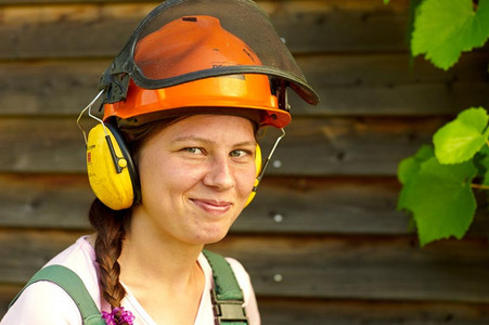 Eine junge lächelnde Frau mit Schutzhelm