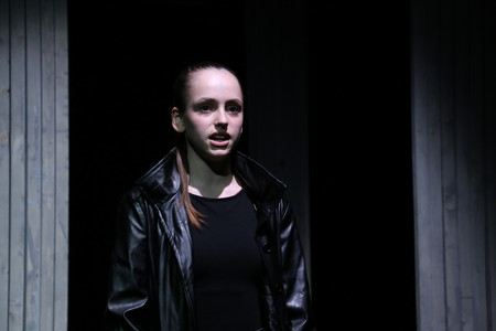 Girls alone on stage in a dark atmosphere