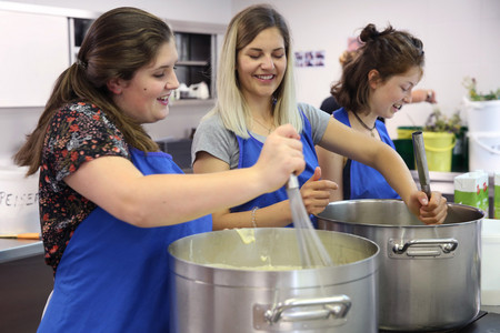 Students stir in pots