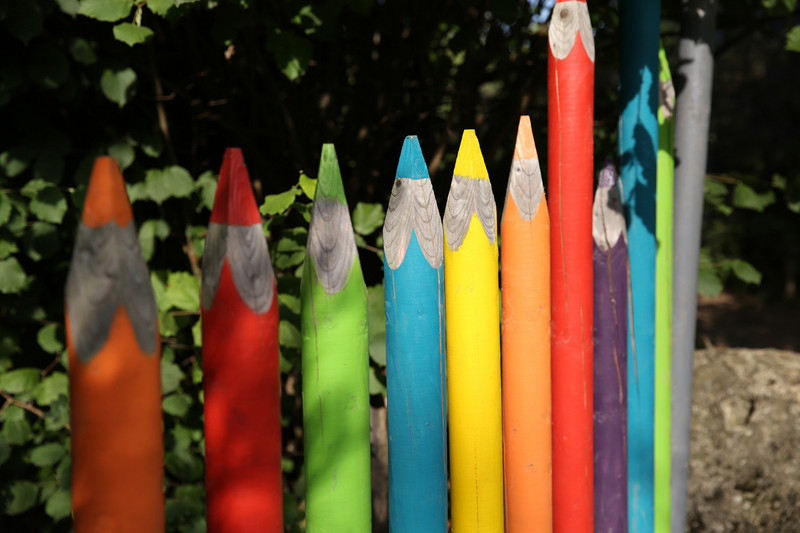 Fence made out of big wooden colored pencils