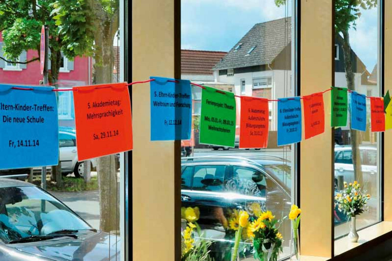 A string in front of a window with pictograms of all the events of the last two years at the scholarship 