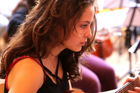 A teenager playing the guitar