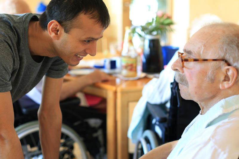 A care taker talks to an older man