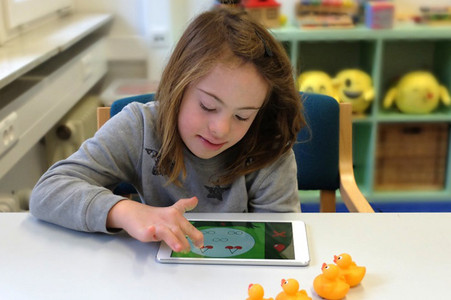 A girl with a tablet is using Mathildr App to learn