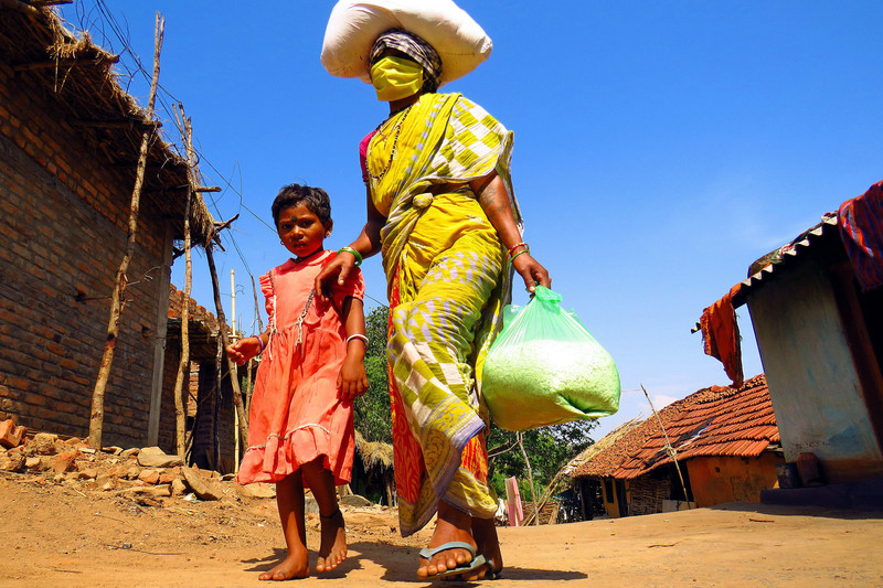 Mother with mask and child in Indian slums