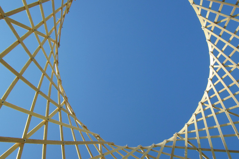 View from bottom to top through the inner part of the airy wooden sculpture